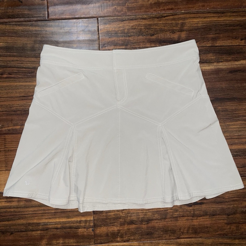 ATHLETA All Terrain Skirt Beige Tan Size 12 Pleated Pockets Hiking Normcore